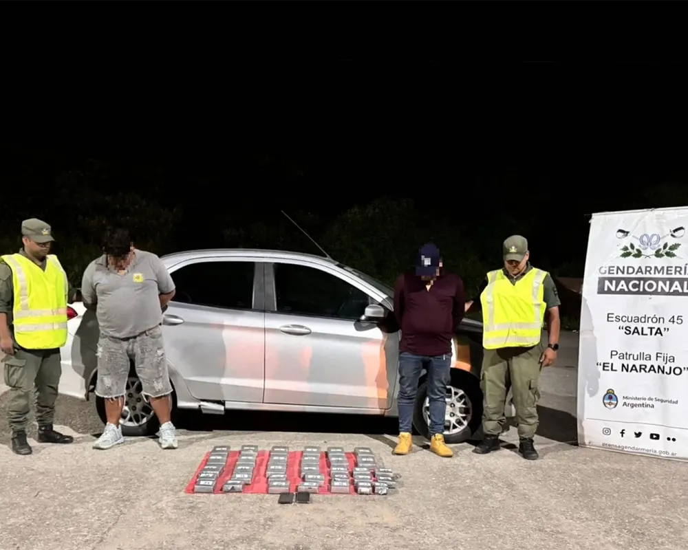 gendarmes junto a los detenidos y la cocaína decomisada