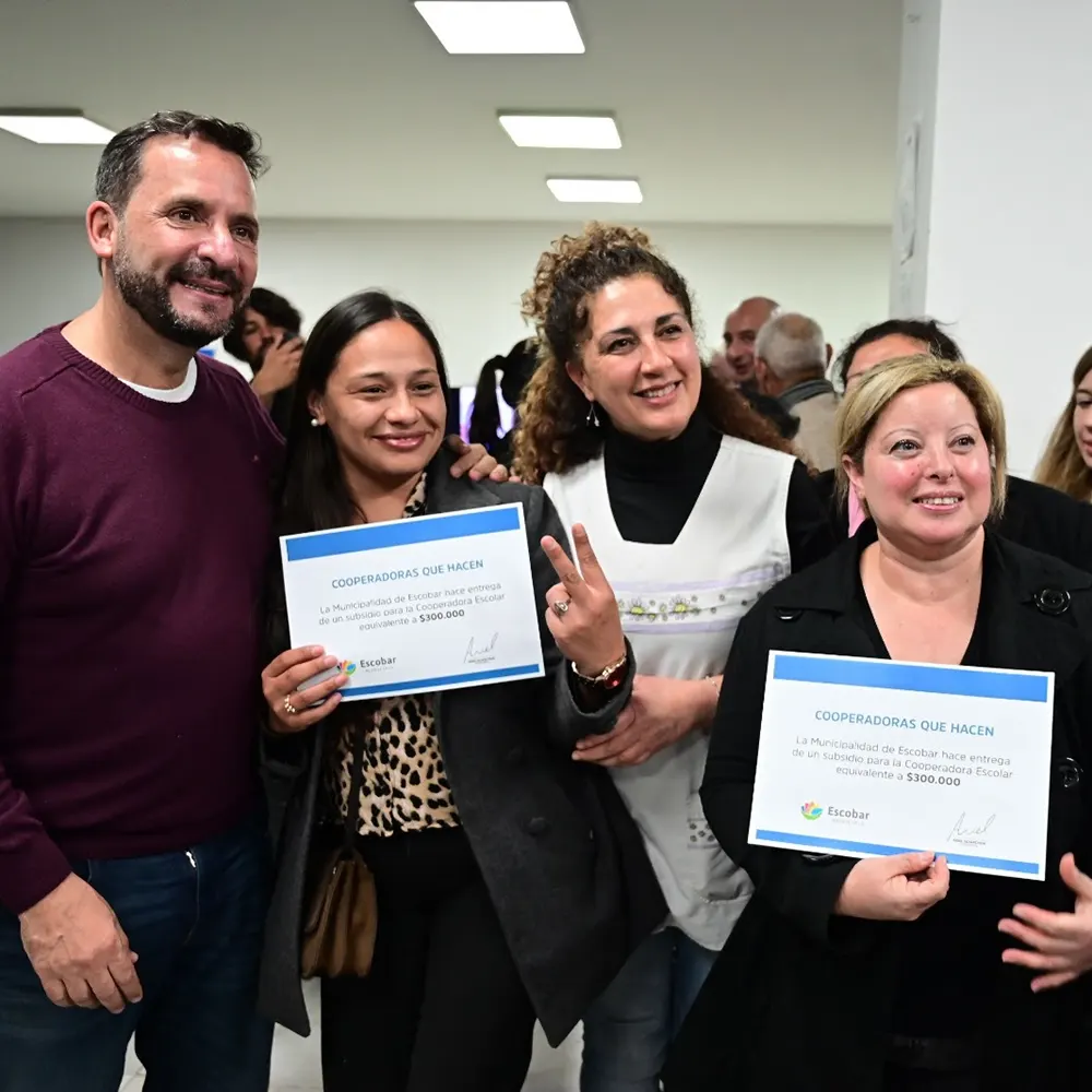 Cooperadoras sosteniendo los certificados del subsidio escolar entregados por Ariel Sujachuk.
