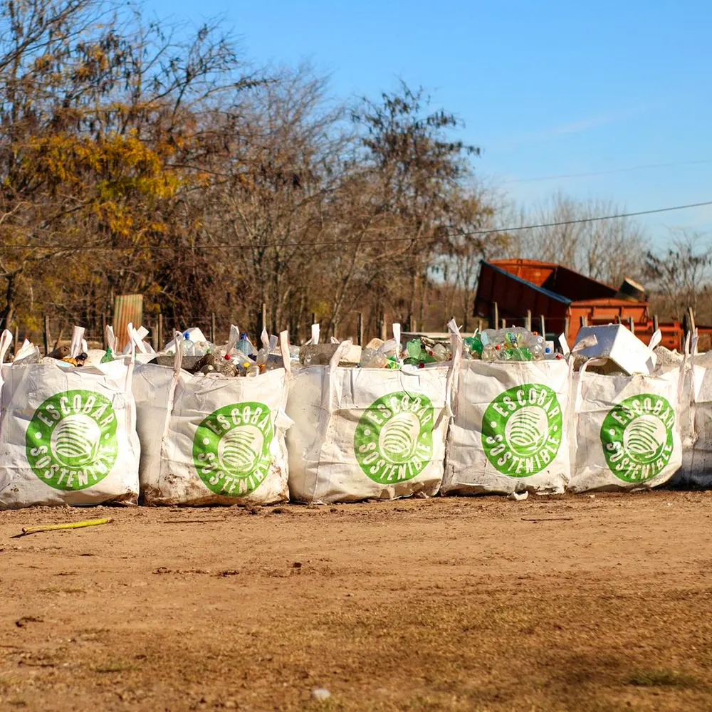 Bolsones blancos con el logo de “Escobar Sostenible”, repletos de residuos recolectados tras la limpieza del arroyo Pinazo.
