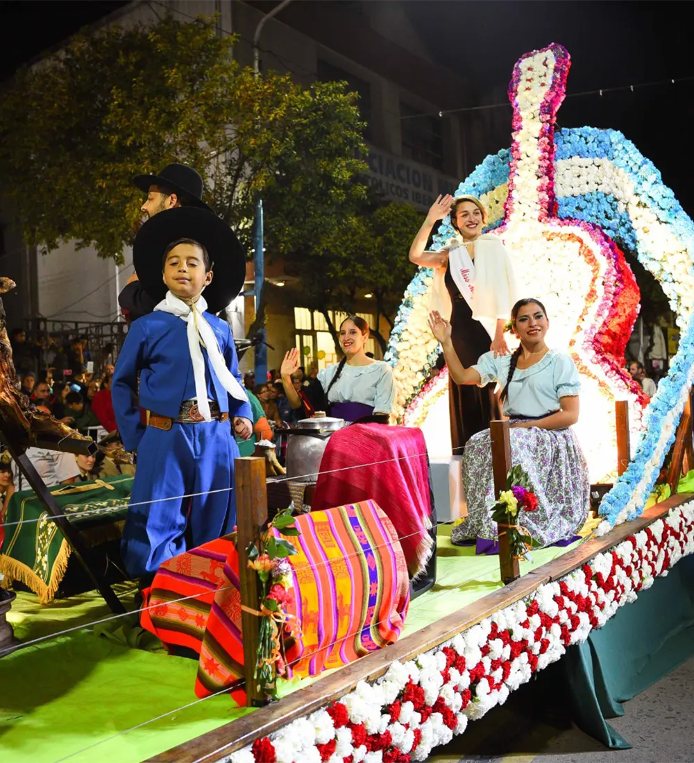 Carroza alegórica a la tradición con una guitarra gigante confeccionada con flores