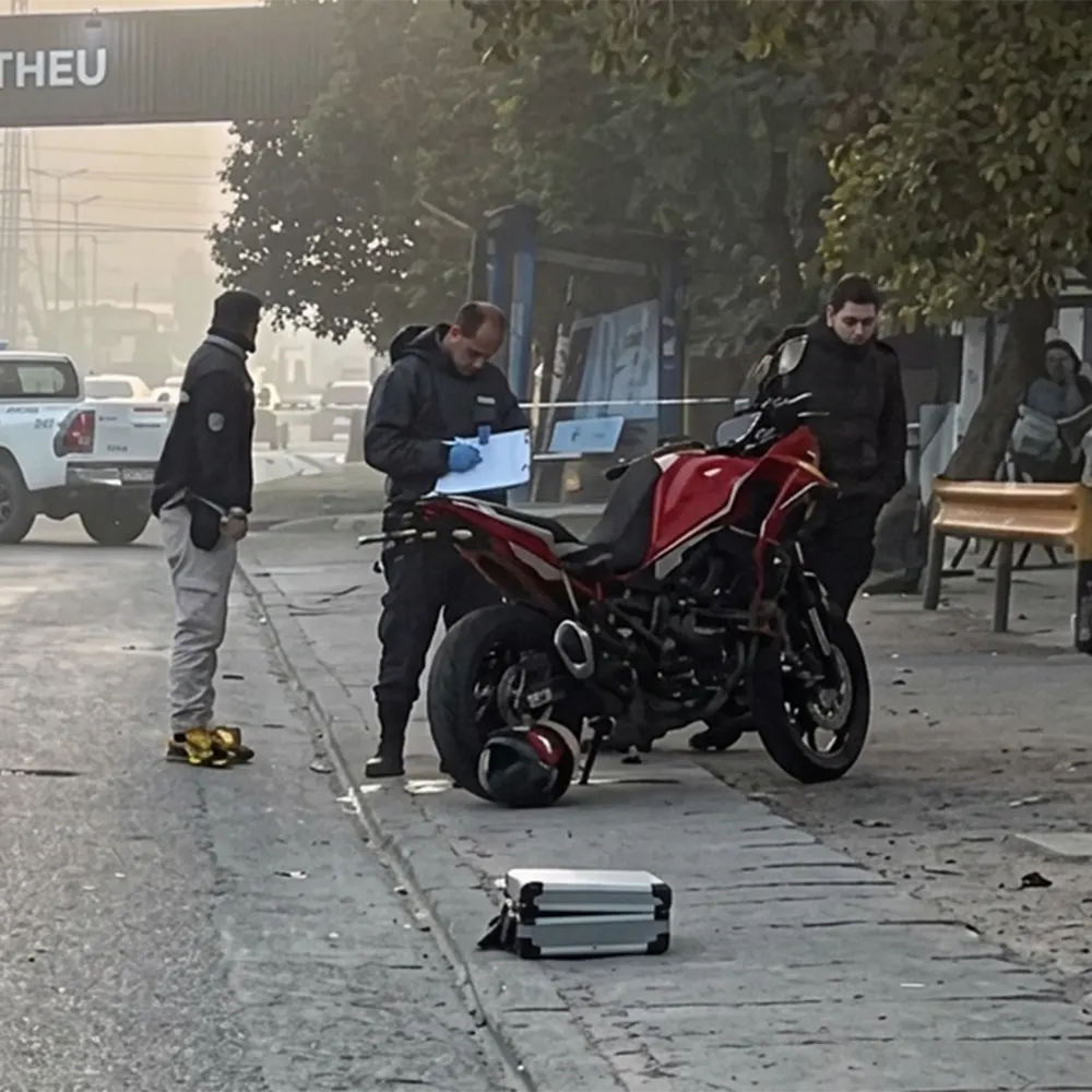 Los efectivos policiales con la moto tras el choque.