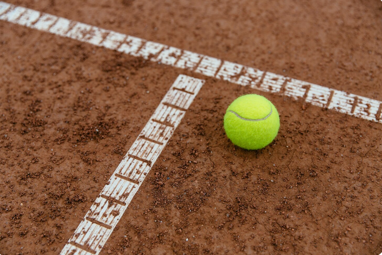 pelota de tenis sobre una cancha de polvo de ladrillo